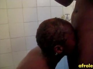 Bald lesbian african woman gives head in shower